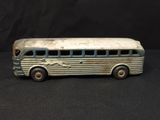 toy bus on a black surface with a black background