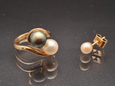 pair of pearl and gold rings and earrings on a black surface
