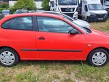 a red car that is parked in the grass
