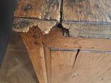 a piece of wood that has been torn off of the top of a wooden box
