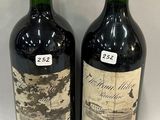two bottles of wine sitting next to each other on a table