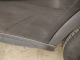 a close up of a car with a flat tire on the ground