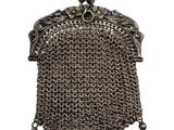 a silver metal purse with a chain around it