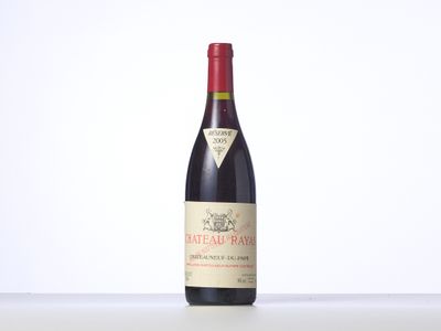 a bottle of red wine sitting on top of a table