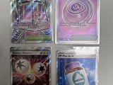 four different types of pokemon cards on a white surface