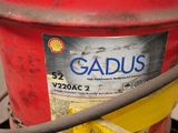 a red gas can with a yellow hose attached to it