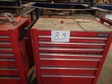 many red tool boxes with numbers on them in a warehouse