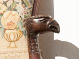 a statue of a bird sitting on a chair