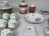 a table with a lot of dishes and cups on it