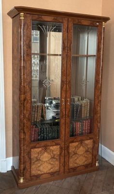 a large wooden cabinet with many books on top of it