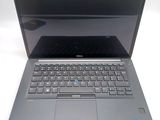 a dell laptop with a blue keyboard on it