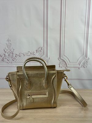 gold leather handbag on a wooden table with a white wall in the background