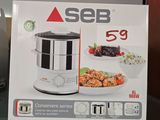 someone is holding a box of food in front of a microwave