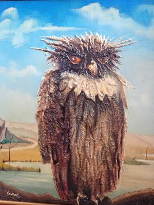 tableau représentant un hibou perché sur une branche devant un paysage désertique