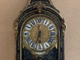 a black and gold clock sitting on a table