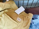 a pile of clothes that is sitting on a shelf