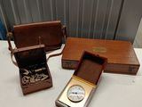 a small wooden box with a clock inside of it