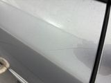the car door is dirty with the paint on the side of it