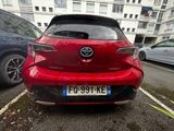 the rear end of a red toyota c - hr parked in a parking lot