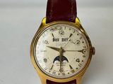 a close up of a wrist watch with a moon on the face