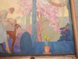 a painting on the wall of a building with a woman feeding a deer