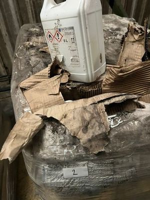 a white container sitting on top of a pile of cardboard