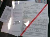 a pile of papers sitting on the seat of a car