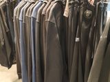 a lot of clothes hanging on a rack in a store