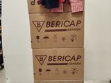 boxes stacked on top of each other in a room with clothes on them