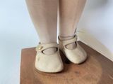 someone is standing on a wooden table with a pair of shoes
