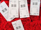several price tags on a red dress with a price tag attached to it
