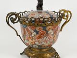 a decorative vase with a lion on it on a stand