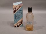 a small bottle of hair oil next to a box of hair oil