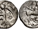 a silver coin with an image of a man and a woman on it