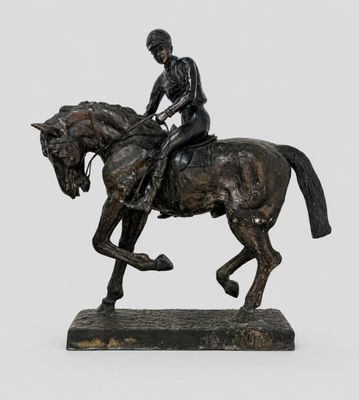 bronze statue of a man riding a horse on a marble base