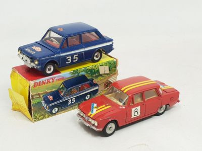 three toy cars sitting next to each other on a white surface
