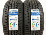 a pair of tires on a white background with a red label