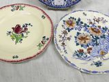 three plates with different designs on them sitting on a table