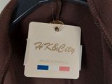 the label is on the jacket of a man ' s brown jacket
