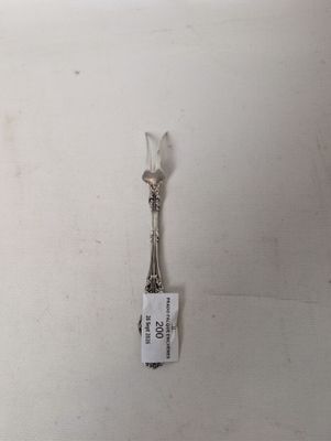 a picture of a silver spoon with a tag attached to it