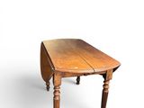 an old wooden table with a drop leafed top on a white background