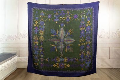 an image of a green and blue tapestry hanging from a wall