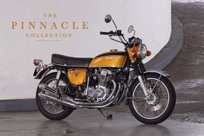 a yellow motorcycle parked in front of a white wall
