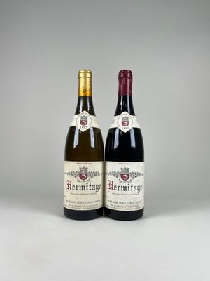 two bottles of wine sitting next to each other on a table