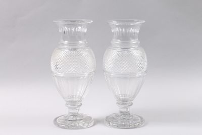 pair of clear glass vases sitting on top of a white table