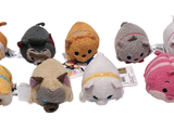 several small stuffed animals are lined up in a row on a white surface