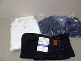 three pairs of jeans and a t - shirt sitting on a bed