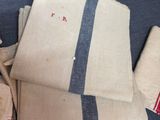 a pile of towels on a table with a blue table cloth