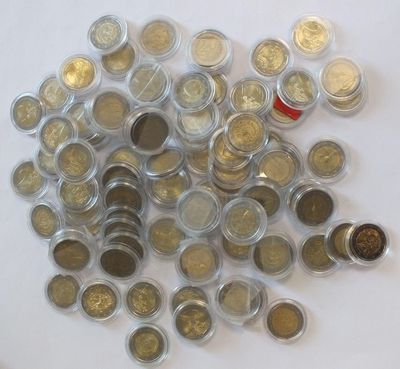 a pile of coins sitting on top of a white table