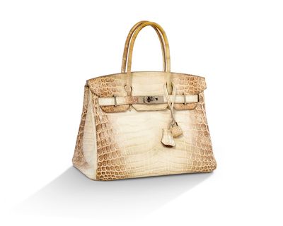 un sac à main en peau d'alligator blanche sur fond blanc